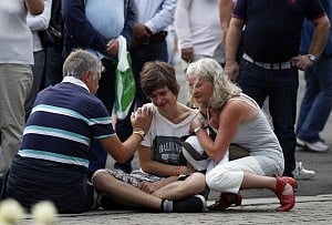 A young man is comforted as he mourns for the victims of the massacre on an island in the countryside and the bomb blast in the capital Oslo July 23, 2011. Photo: Reuters 