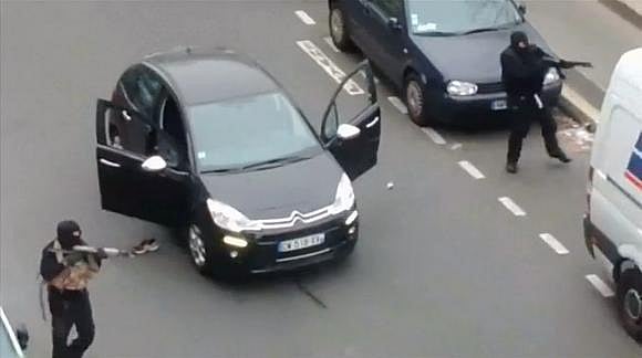 Gunmen flee the offices of Charlie Hebdo in Paris. Photo credit: Reuters. 