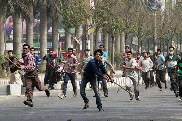 Bangladesh Jamaat-e-Islami activists throw bricks in clashes with Dhaka police. REUTERS/Andrew Biraj. 