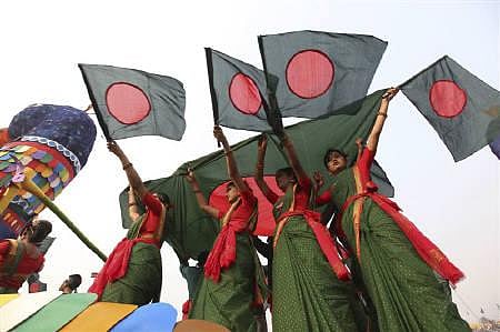 Performers wave national flags during a Victory Day parade. REUTERS/Andrew Biraj. 