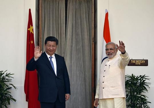 India's Prime Minister Narendra Modi and China's President Xi Jinping wave to the media. Photo: Reuters. India's Prime Minister Narendra Modi and China's President Xi Jinping wave to the media. Photo: Reuters.