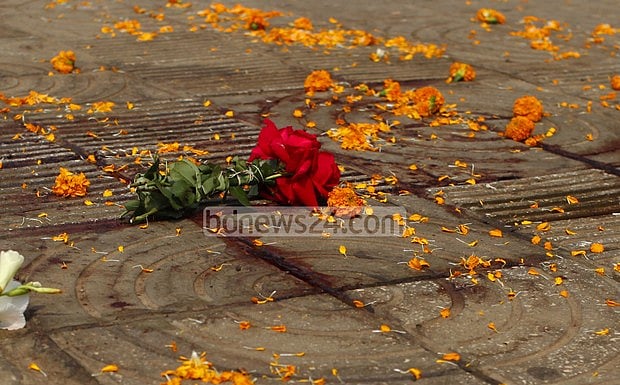 Flowers left at pavement where writer Abhijit Roy was killed. 