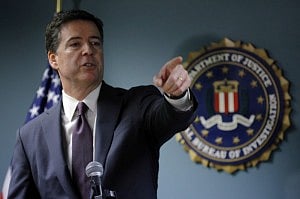 FBI Director James Comey takes a question at a news conference in the FBI office in Boston, Massachusetts, November 18, 2014. REUTERS/Brian Snyder. 