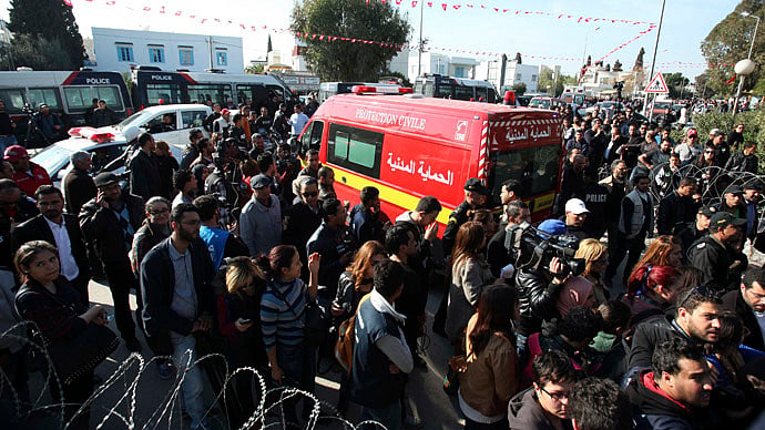 People surround an ambulance carrying the bodies of the victims of an attack by gunmen on Tunisia's national museum in Tunis March 18, 2015. (Reuters / Zoubeir Souissi) 