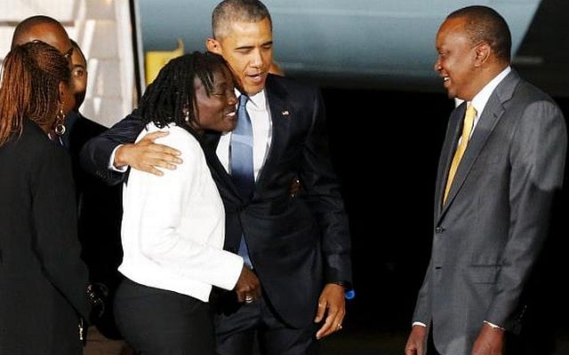 US President Barack Obama (2nd L) embraces his half-sister Auma Obama (L) and is greeted by Kenya's President Uhuru Kenyatta (R) as he arrives aboard Air Force One at Jomo Kenyatta International Airport in Nairobi July 24, 2015. REUTERS 
