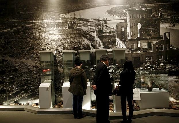 Visitors stand in front of a photograph showing Hiroshima city after the 1945 atomic bombing as they look at artifacts from the destruction caused by the bomb, at Hiroshima Peace Memorial Museum in Hiroshima, western Japan. REUTERS/Issei Kato 