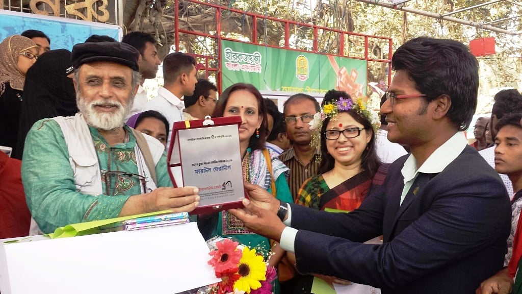 কবি নূরুল হুদার কাছ থেকে সচেতন নাগরিক সচেতন ব্লগার সম্মাননা নিচ্ছেন ফারদিন ফেরদৌস। 