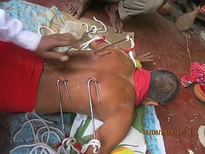 চারটি মোটা ধারালো হুক বিদ্ধ করা হয়েছে সন্ন্যাসীর পিঠে। 