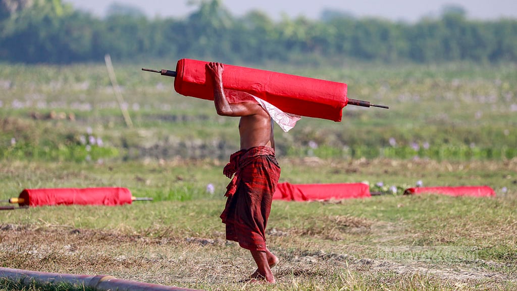 After being dyed red, the cloth is taken to open fields to dry under the sun.