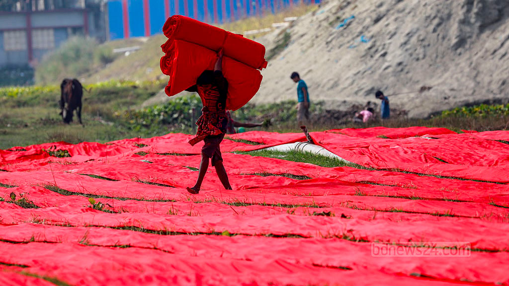 The folded cloth is then delivered by workers to the traders.