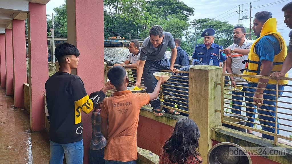 সুনামগঞ্জের ছাতক উপজেলার একটি আশ্রয়কেন্দ্রে দুপুরের খাবার বিতরণ করছেন পুলিশ বাহিনীর সদস্যরা।