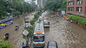 Dhaka residents trudge through waterlogged streets
