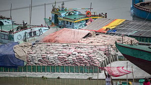 Barges laden with cement wait for road transport