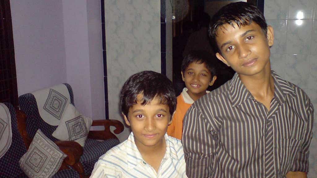 Three brothers look on -- Dipto (right), Mugdho (left), and Snigdho (in the back).