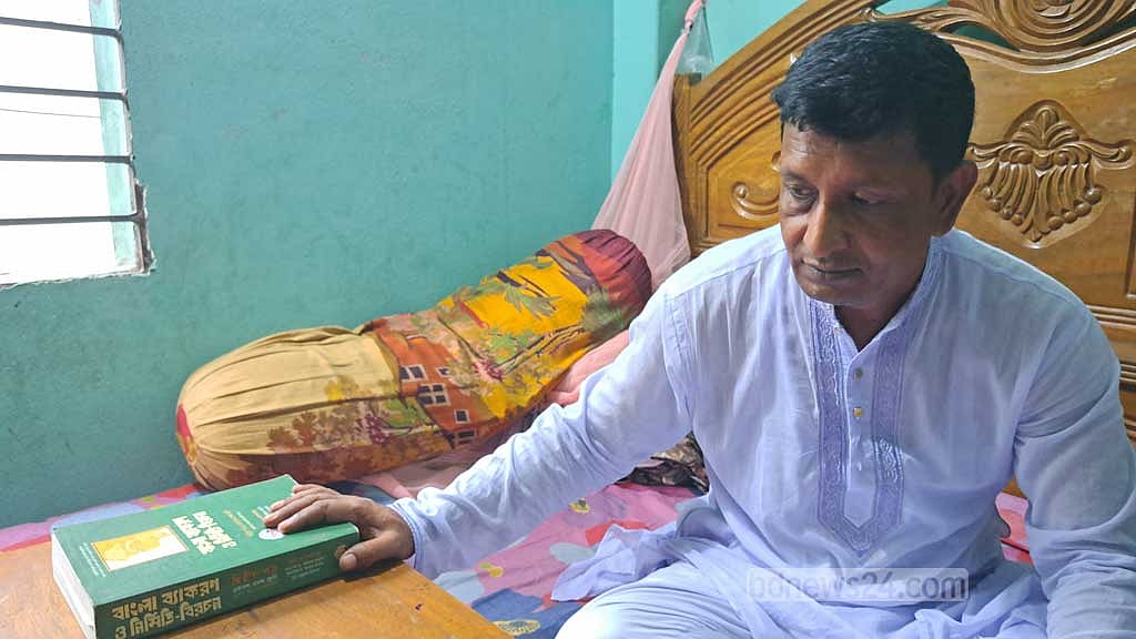 Overwhelmed by grief, Abul Hossain trying to show his daughter’s books.