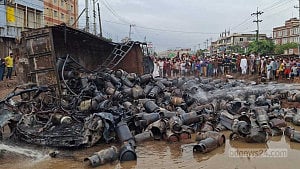 Truck carrying gas cylinders overturns, causes blast