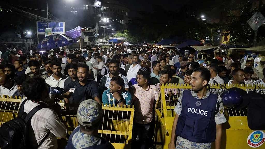 Outsiders gather near campus gates during DUCSU vote counting.