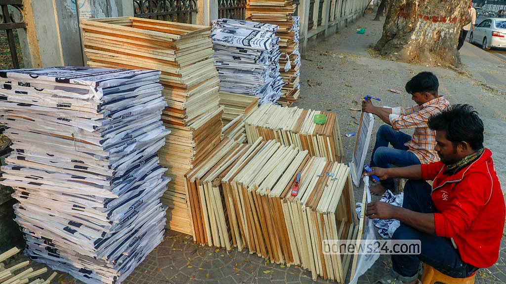 এবার কাগুজে পোস্টার ব্যবহারের সুযোগ না থাকায় ব্যস্ততা বেড়েছে ফ্রেম কারিগরদের। কাপড়ে ছাপা প্রচারপত্র ফ্রেমে সেঁটে দেন তারা। 