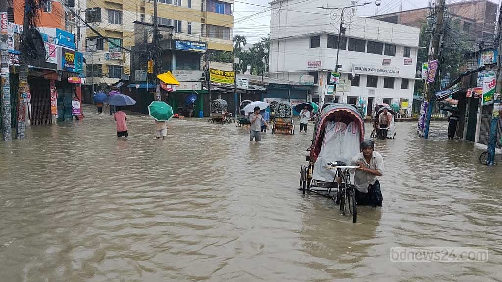 চকবাজারের তেলিপট্টি মোড় এলাকার জলাবদ্ধতায় দুর্ভোগ পোহাতে হচ্ছে ঘর থেকে বের হওয়াদের। ছবি: সুমন বাবু 