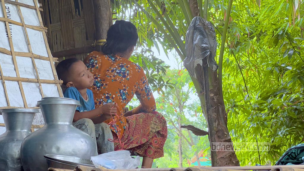 Carrying deep frustration and grief, Dukmala Tongchongya turns away from the camera.