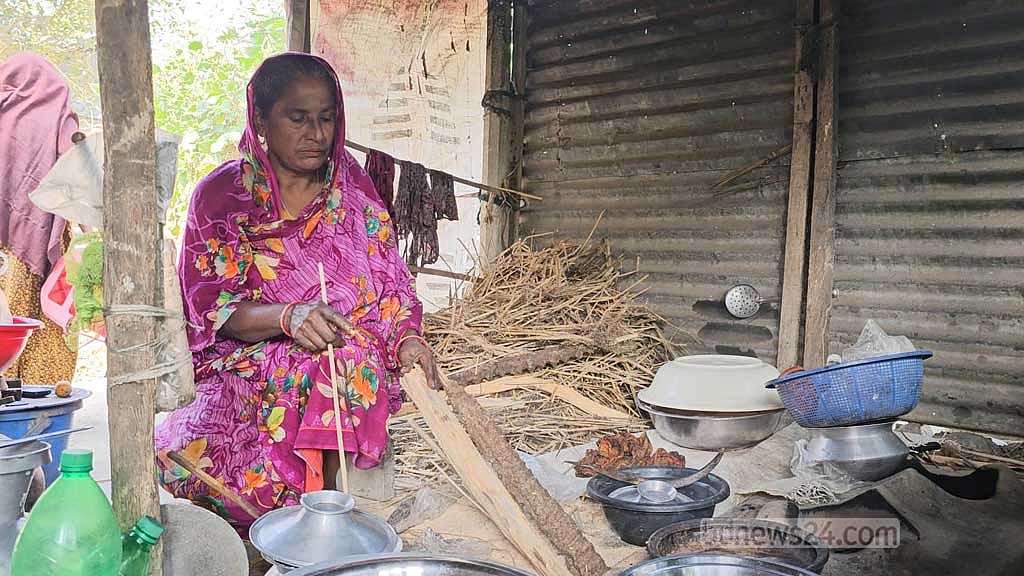 Kamal Hossain’s mother Anwara Begum cooking at her home.