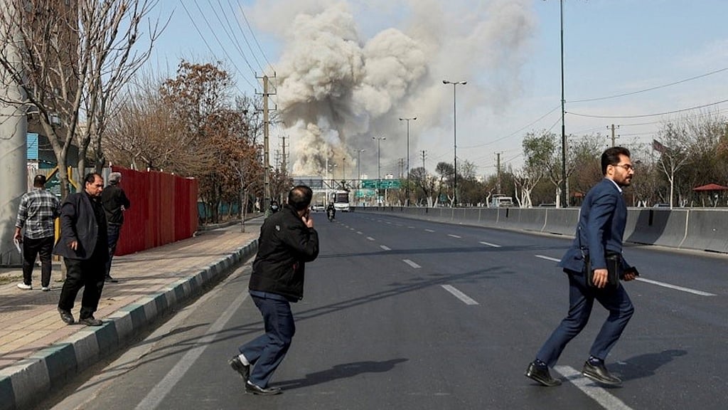 People run as smoke rises following an explosion, amid the US-Israeli conflict with Iran, in Tehran, Iran, Mar 5, 2026. REUTERS