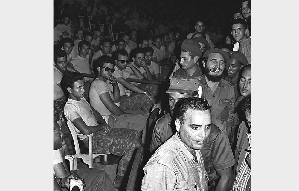 Fidel Castro (3rd row, R) enters a public trial for captured members (seated) of the failed Bay of Pigs invasion in Havana in April 1961. Reuters 