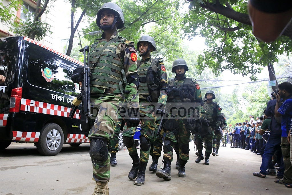 Soldiers come out of Holey Artisan as their operation ends. 