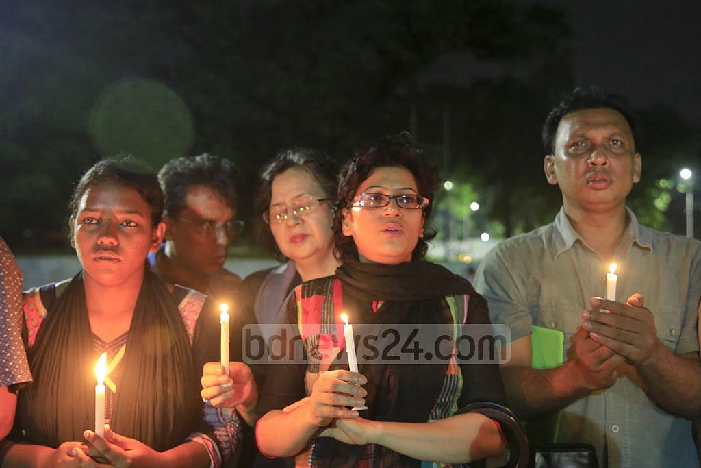 Candles were lit for the victims during a gathering organised at Central Shaheed Minar by Sammilito Sangskritik Jote on Jul 3. 