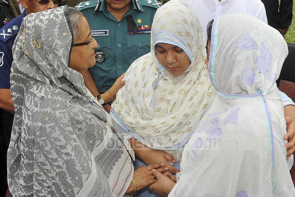 The prime minister speaks to family members of the three Bangladeshi victims. 