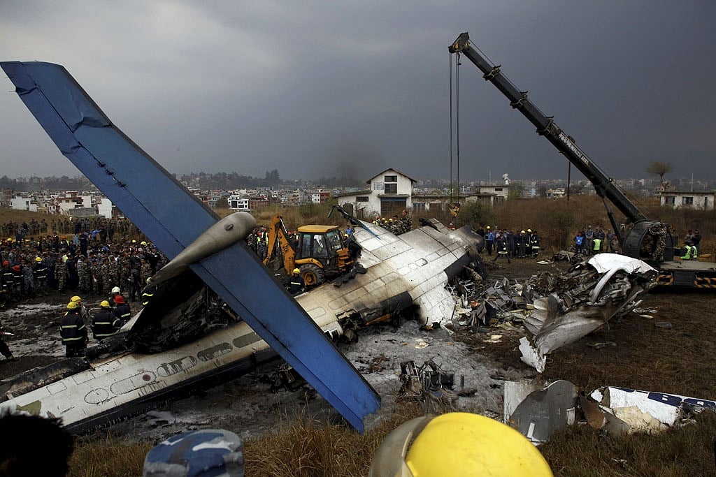 Rescue workers work at the wreckage of a US-Bangla airplane after it crashed at the Tribhuvan International Airport in Kathmandu, Nepal March 12, 2018. REUTERS 
