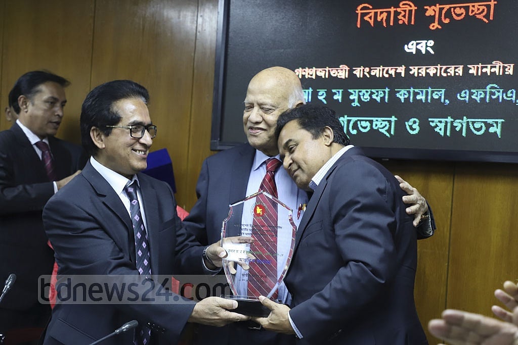 AHM Mustafa Kamal and Abul Maal Abdul Muhith share a rare moment at a ceremony at the National Board of Revenue on Thursday, Jan 24, 2019.  