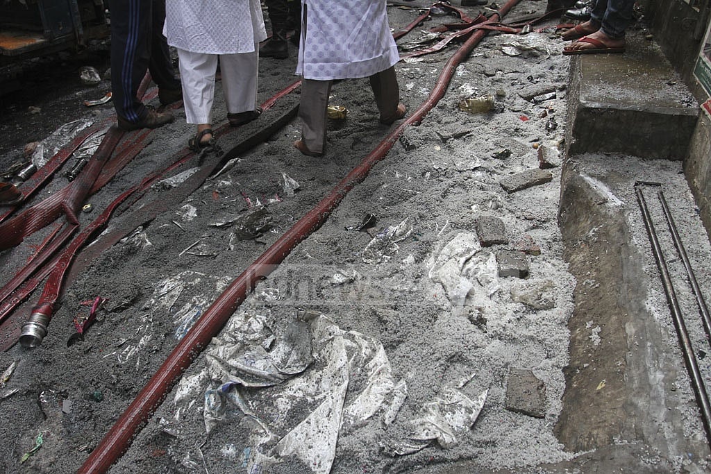 Bottles of perfume, air-fresheners and raw materials for making plastic bags litter the narrow alley where a massive fire razed at least five buildings and several cars on Wednesday night. Inflammable materials stored in several buildings caused the fire to grow into a massive blaze. Photo: Asif Mahmud Ove Bottles of perfume, air-fresheners and raw materials for making plastic bags litter the narrow alley where a massive fire razed at least five buildings and several cars on Wednesday night. Inflammable materials stored in several buildings caused the fire to grow into a massive blaze. Photo: Asif Mahmud Ove