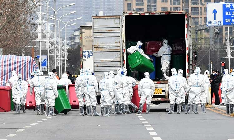 Workers in protective suits take part in the disinfection of Huanan seafood market, where the novel coronavirus is believed to have first surfaced, in Wuhan, Hubei province, China Mar 4, 2020. REUTERS 