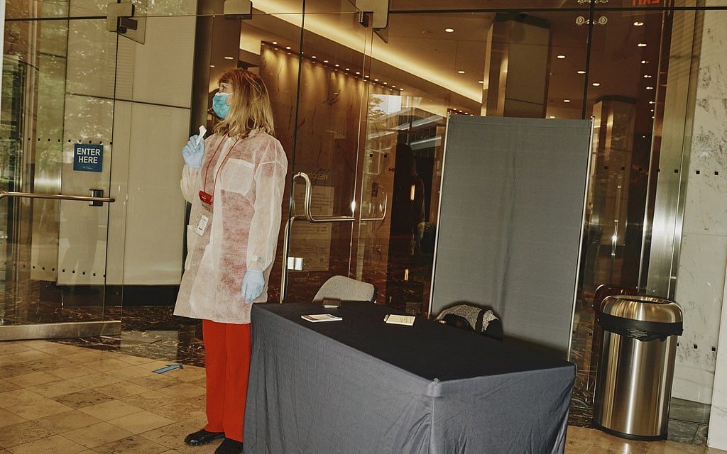 A temperature check station next to an bank of elevators at the Prudential Center in Boston on June 22, 2020. The elevator ride, a previously unremarkable 90 or so seconds, has become a daunting puzzler in the calculus of how to bring people back to work safely after the coronavirus pandemic kept them home for months. (Tony Luong/The New York Times) 