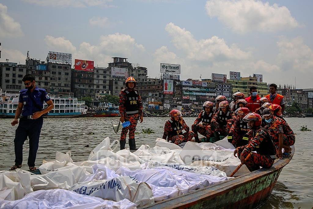 Fire service members transferring the bodies of those dead in the Buringanga launch capsize to the morgue of Mitford Hospital. Photo: Mahmud Zaman Ovi 