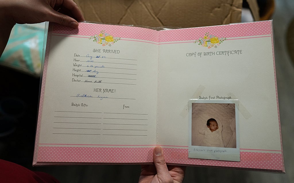 Rebecca Trimble’s husband shows a baby scrap book that her parents created, in Bethel, Alaska, March 8, 2020. (Ash Adams/The New York Times) Rebecca Trimble’s husband shows a baby scrap book that her parents created, in Bethel, Alaska, March 8, 2020. (Ash Adams/The New York Times)