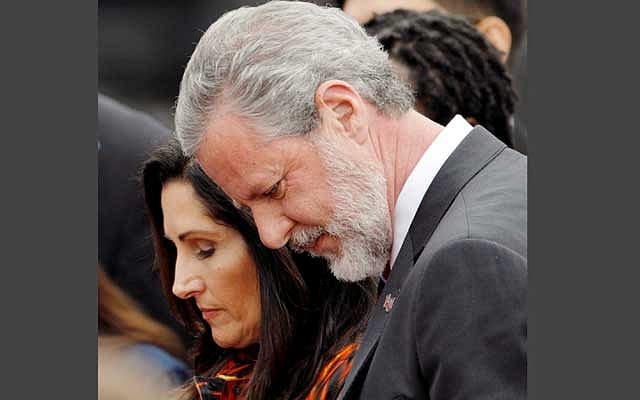 Liberty University President Jerry Falwell Jr. and his wife Becki Tilley bow their heads in a prayer after commencement ceremonies at Liberty University in Lynchburg, Virginia, US, May 11, 2019. Reuters 