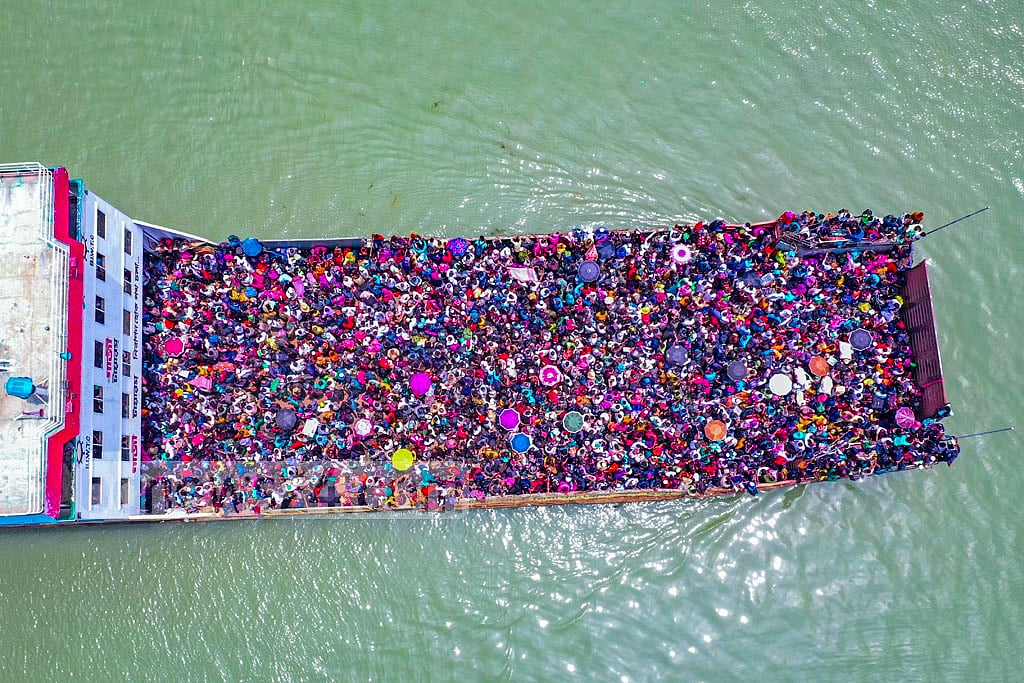  May 08, 2021: Bangladesh Inland Water Transport Corporation decided to suspend daytime ferry services on the Shimulia-Banglabazar route due to COVID-19 concerns. Unable to cope with an onrush of travellers, a ferry packed to the brim leaves the port. Photo: Mostafigur Rahman  May 08, 2021: Bangladesh Inland Water Transport Corporation decided to suspend daytime ferry services on the Shimulia-Banglabazar route due to COVID-19 concerns. Unable to cope with an onrush of travellers, a ferry packed to the brim leaves the port. Photo: Mostafigur Rahman