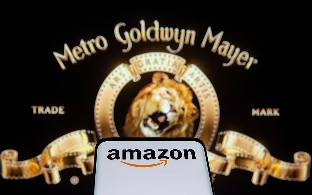Smartphone with Amazon logo is seen in front of displayed MGM logo in this illustration taken, May 26, 2021. Reuters 