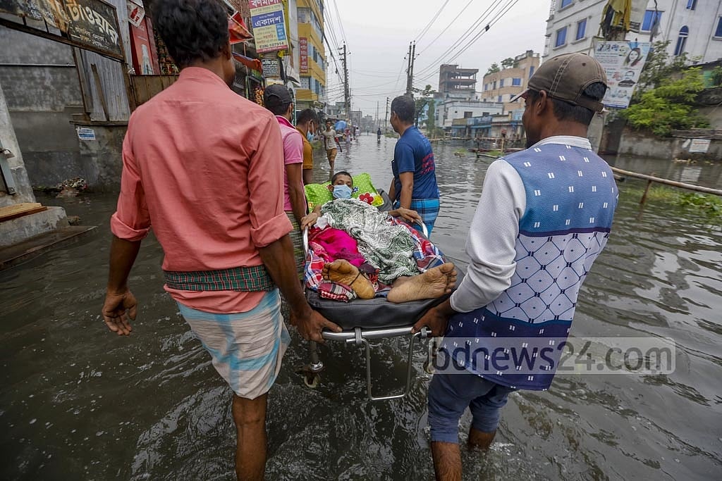 Jun 01, 2021: A patient is being taken home on a stretcher after his ambulance from Dhaka Medical College Hospital was stuck on an inundated road in Rasulpur, Dhania. Waterlogging brought much suffering to residents across Dhaka. Photo: Mahmud Zaman Ovi Jun 01, 2021: A patient is being taken home on a stretcher after his ambulance from Dhaka Medical College Hospital was stuck on an inundated road in Rasulpur, Dhania. Waterlogging brought much suffering to residents across Dhaka. Photo: Mahmud Zaman Ovi