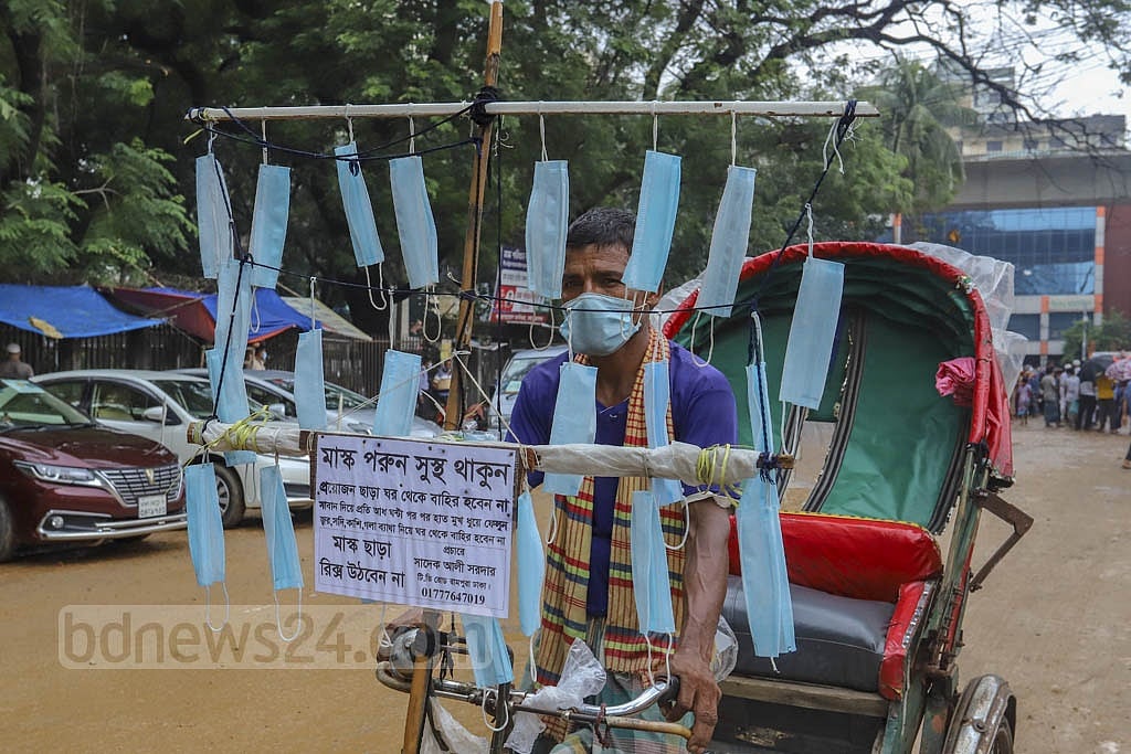 Jul 01, 2021: Wearing a mask is an essential part of the hygiene rules designed to curb the coronavirus pandemic. Sadek Ali Sardar, a rickshaw-puller, decorated his three-wheeler with masks to create public awareness about face coverings. Photo: Asif Mahmud Ove Jul 01, 2021: Wearing a mask is an essential part of the hygiene rules designed to curb the coronavirus pandemic. Sadek Ali Sardar, a rickshaw-puller, decorated his three-wheeler with masks to create public awareness about face coverings. Photo: Asif Mahmud Ove