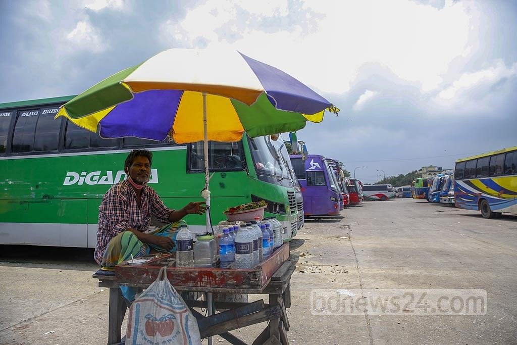 Jul 13, 2021: Mohammad Sohag has been selling betel leaf, cigarettes and water at Gabtoli Bus Terminal in Dhaka for two decades. His sales have dropped from around Tk 2,000 a day to almost nothing as the public transportation system was shut down amid the coronavirus lockdown. Now, he sells products worth Tk 200 to Tk 300 a day, and the meagre profit is not enough to run his family. Photo: Mahmud Zaman Ovi  Jul 13, 2021: Mohammad Sohag has been selling betel leaf, cigarettes and water at Gabtoli Bus Terminal in Dhaka for two decades. His sales have dropped from around Tk 2,000 a day to almost nothing as the public transportation system was shut down amid the coronavirus lockdown. Now, he sells products worth Tk 200 to Tk 300 a day, and the meagre profit is not enough to run his family. Photo: Mahmud Zaman Ovi 