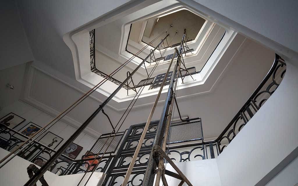 Rails and cables of a Schindler elevator ascend the floors of a 1920 art deco building in the Zamalek neighbourhood of Cairo, Aug 28, 2021. The city’s geriatric lifts, graceful fin-de-siècle and Art Deco pieces from the era when the city competed with London and Paris for wealth and glamour, have been going up and down the same buildings for, in some cases, more than a century. Sima Diab/The New York Times 