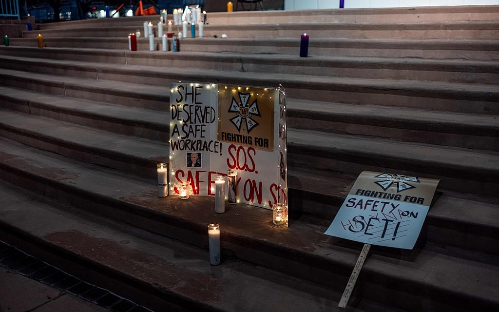 Signs and a makeshift memorial at a vigil in Albuqurque, NM, for the cinematographer Halyna Hutchins, who died on set of the movie “Rust,” Oct 23, 2021. At a vigil for Hutchins a sign alluded to the recent union negotiations over workplace safety. A reconstruction of the events leading up to the fatal shooting of the cinematographer of “Rust,” the Alec Baldwin western, reveals a troubled production and a series of errors.  Sharon Chischilly/The New York Times