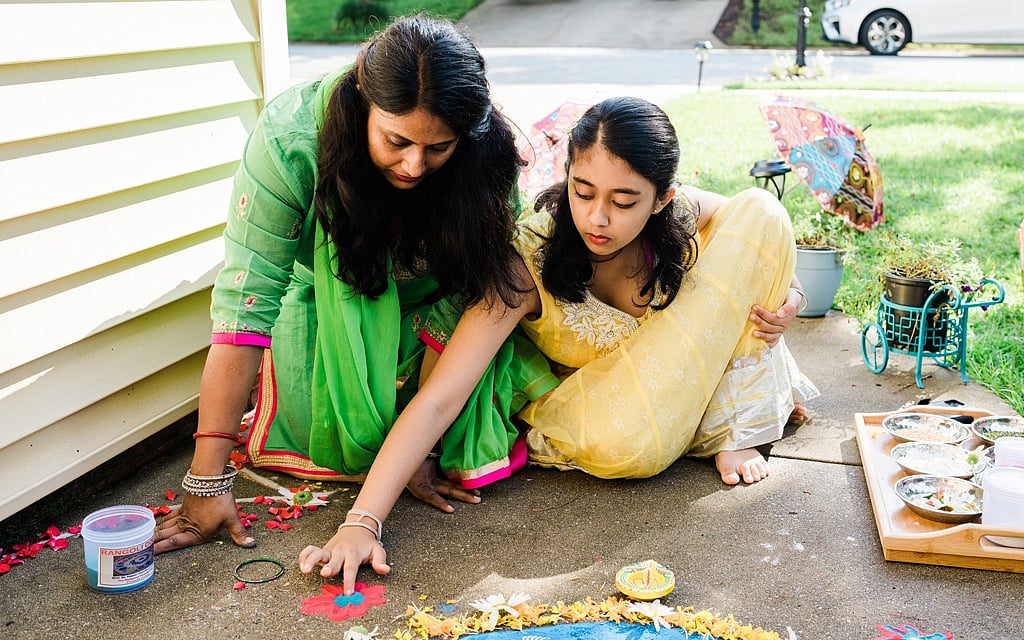 Jugnu Verma and her daughter making rangoli outside their home in Lexington, SC, Jul 17, 2021. Making ornate floor art can be a celebratory act for festivals like Diwali and a meditative practice. Gabriela Bhaskar/The New York Times 