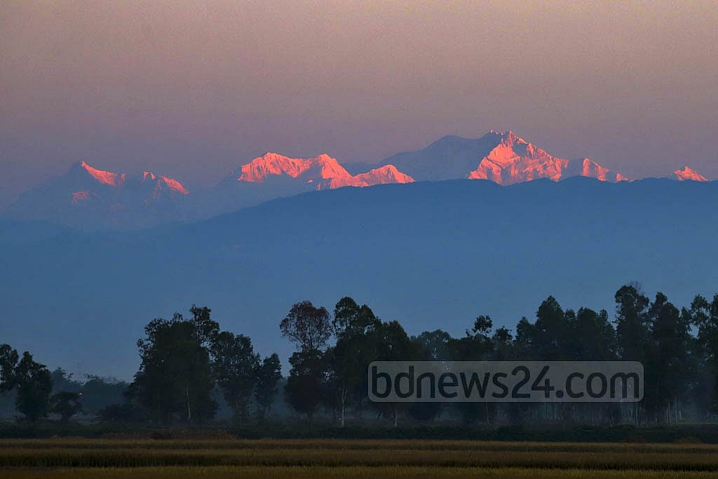 The peak of Kanchenjunga appears dark red from Tetulia at first light. 
