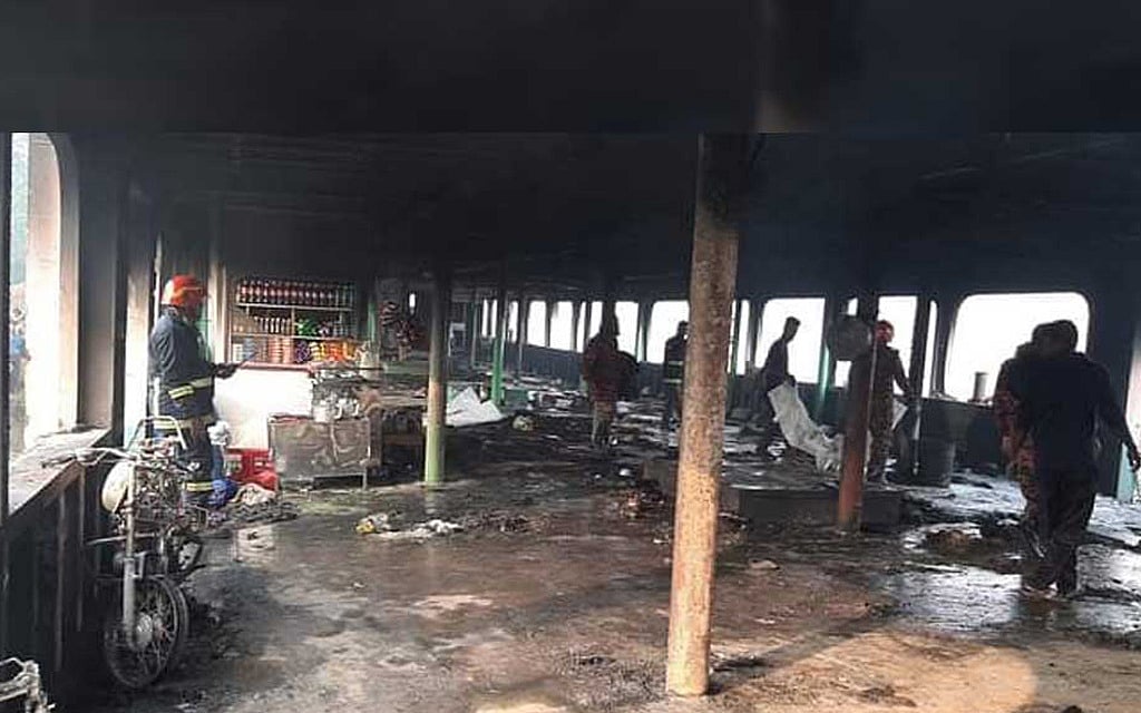 Fire Service personnel recover the bodies of victims after a fire swept through the Barguna-bound MV Abhijan-10 launch on the Sugandha river in the southern district of Jhalakathi on Friday, Dec 24, 2021. 