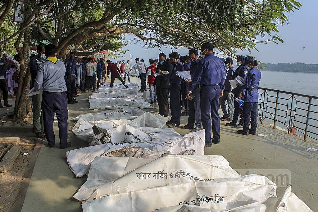The bodies of passengers recovered from the launch MV Abhijan-10 lie on the bank of the Sugandha river on Friday, Dec 24, waiting to be identified. Photo: Hasibul Islam Hasan 