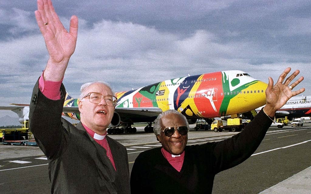 FILE PHOTO: Archbishop Desmond Tutu greets Dr George Carney, Archbishop of Canterbury on his arrival ahead of Sunday's retirement mass for Tutu, June 22. Tutu retires at the end of the month as Archbishop of Cape Town, a post he has held for the past ten years. REUTERS/Mike Hutchings/File Photo 